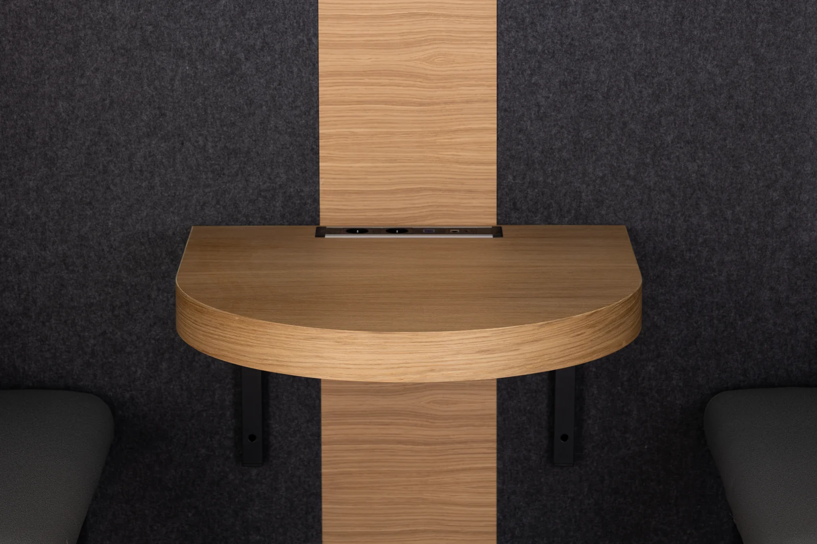 MEAVO Camden interior with a rounded wooden table, integrated connections and grey acoustic lining