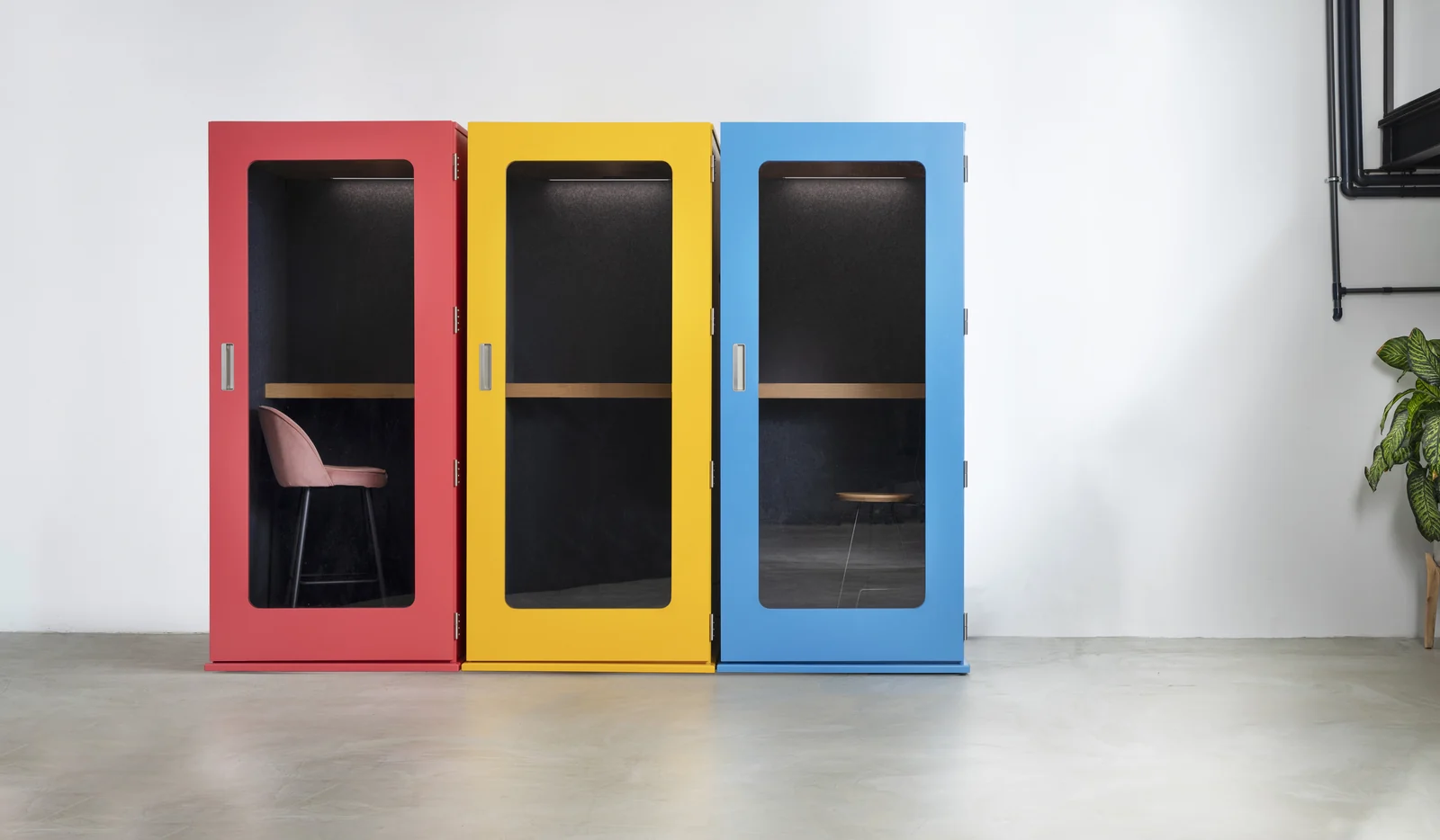 Coral, yellow and blue MEAVO Soho phone booths side by side