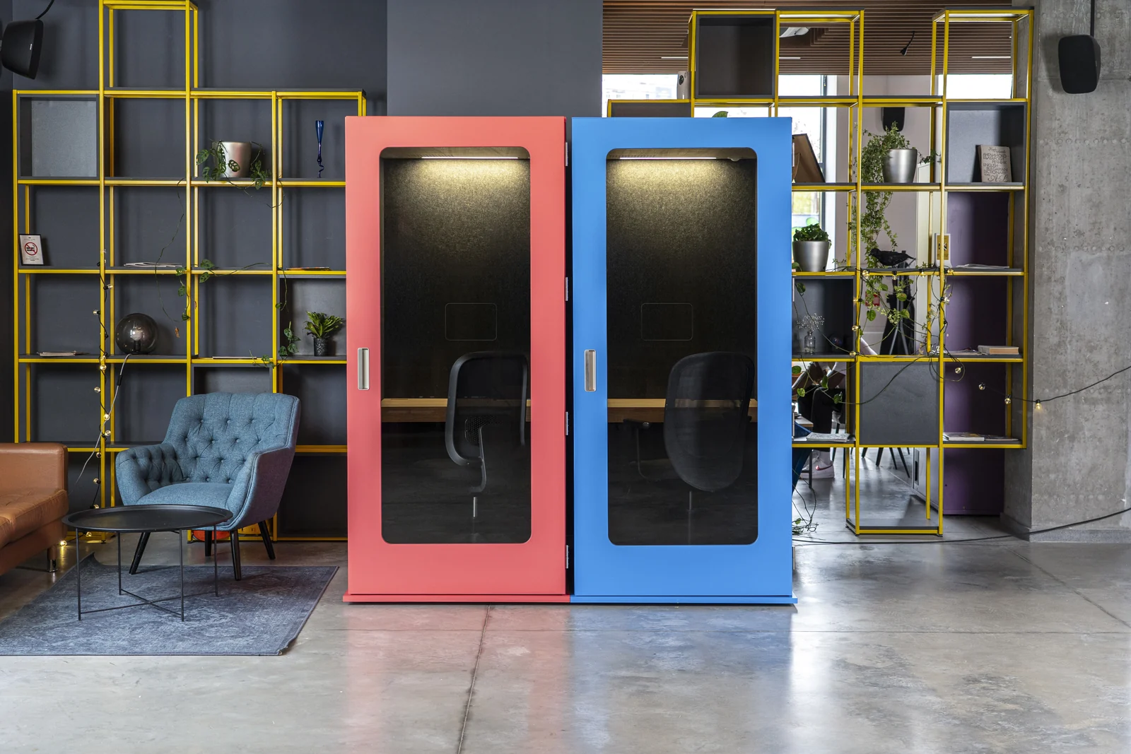 Coral and blue MEAVO Workstation focus pods with desks and office chairs